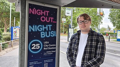 Lib Dem University Ward spokesperson James Hawketts with a night bus sign at UEA. 