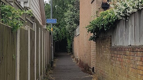 A cyclists dismount sign between Christchurch and Meadow Rise Rds. 